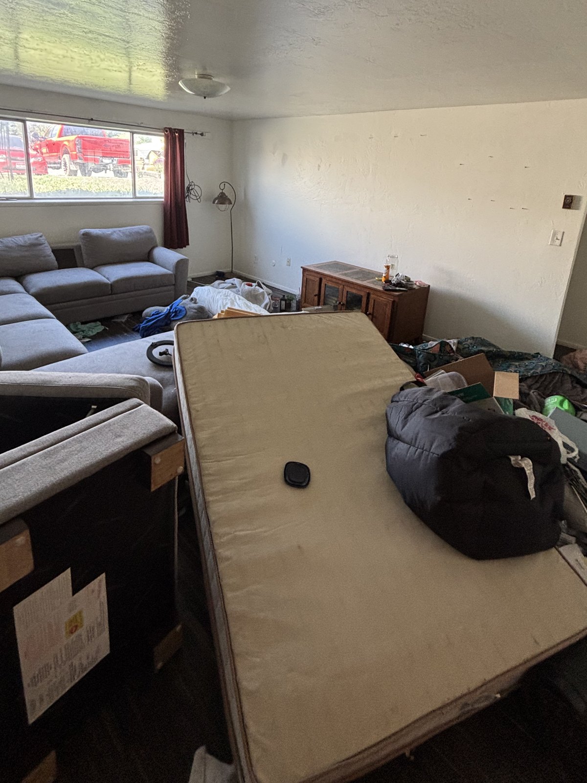Living room before — packed with old furniture and clutter